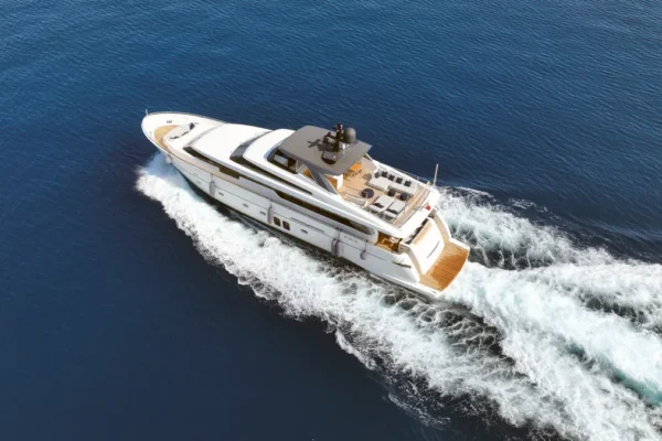 Aerial three-quarter view of the Sanlorenzo 96 luxury yacht cruising in the waters of Porto Cervo, Costa Smeralda, Sardinia.