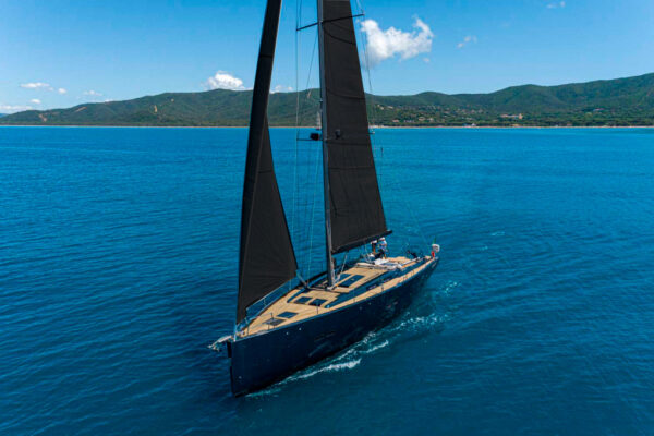 Hanse 575 sailing yacht cruising with sails up near Porto Cervo, Costa Smeralda, Sardinia