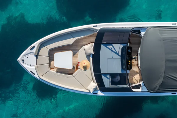 Aerial top-down view of the bow of a BB Yachts Panarea 44 anchored in the turquoise waters of Costa Smeralda, Sardinia.