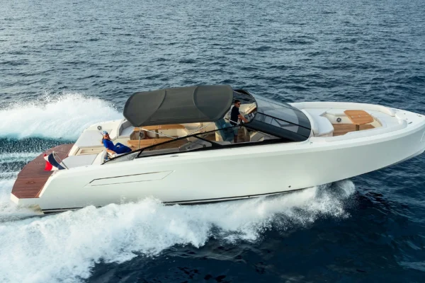 Side view of the BB Yachts Panarea 44 motor yacht in full navigation, creating white wake in the blue sea of Porto Cervo, Costa Smeralda, Sardinia.