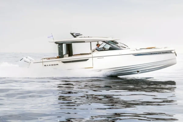 Wide shot of the white Saxdor 400 GTO power yacht cruising on calm Mediterranean waters, perfect for fast and elegant day charters in Costa Smeralda, Sardinia.