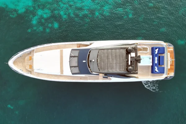 A direct overhead, bird's-eye view of the Amer F100 superyacht's teak decks, showing the forward sunpads and flybridge layout.