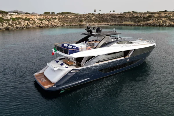 An elevated aft quarter view of the Amer F100 superyacht's stern, beach club, and flybridge.